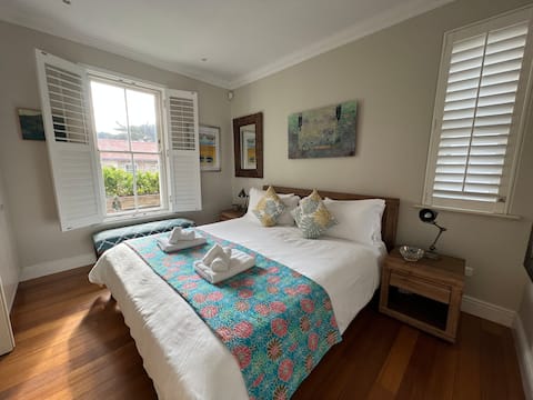King bed in the bedroom of The Majestic Apartment, Kalk Bay